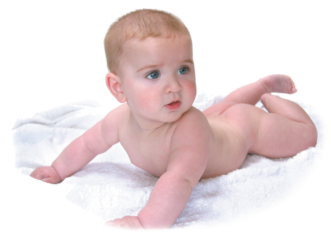 Baby lying on towel | Nourish Baby
