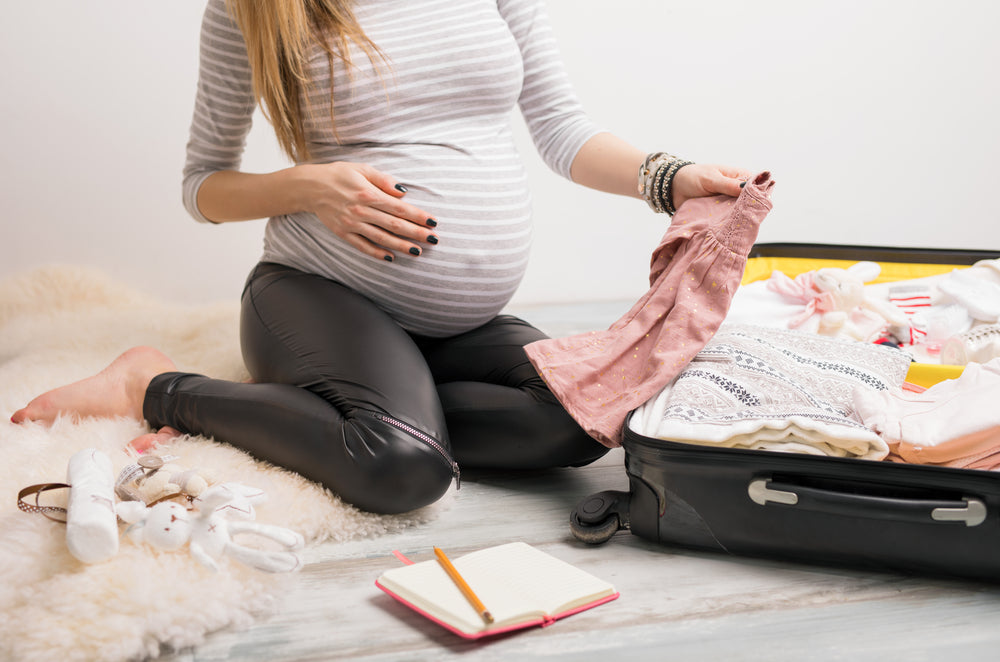 Pregnant woman packing hospital bag | Nourish Baby