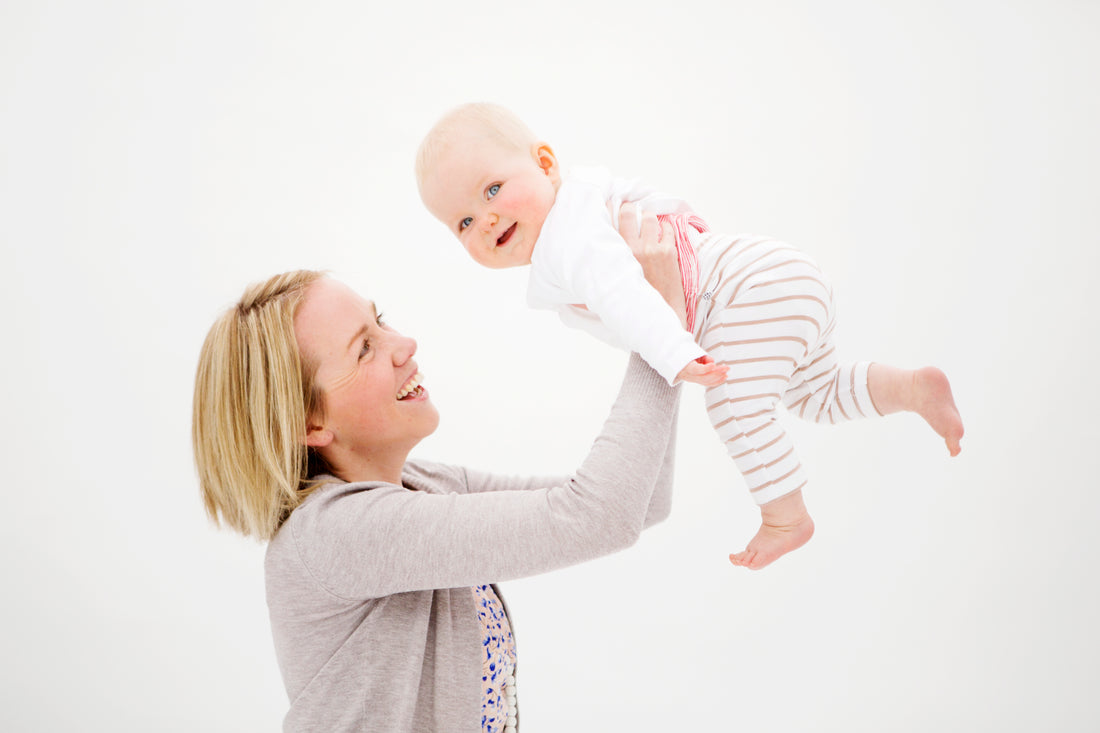 Mum holding baby in the air | Nourish Baby