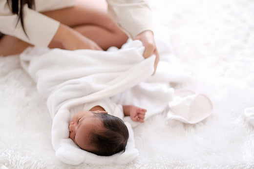 Mother wrapping baby | Nourish Baby