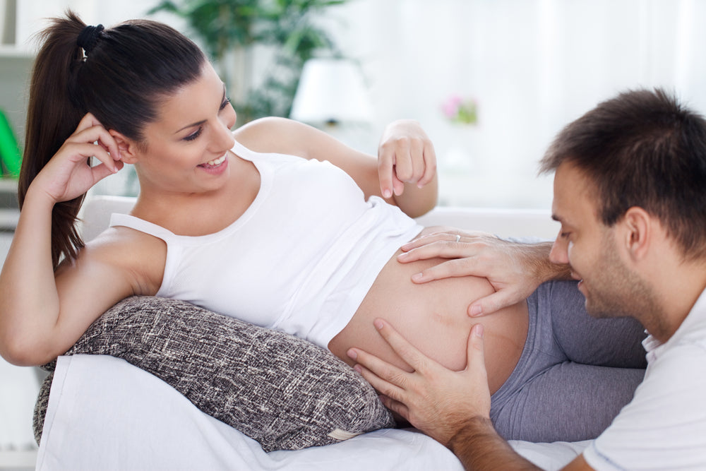 dad feeling pregnant woman's tummy