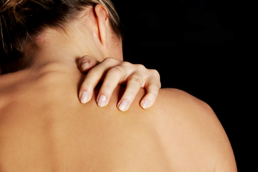 Woman scratching back  | Nourish Baby