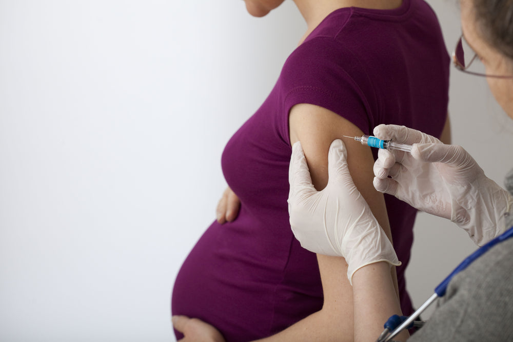 Pregnant woman receiving an injection | Nourish Baby