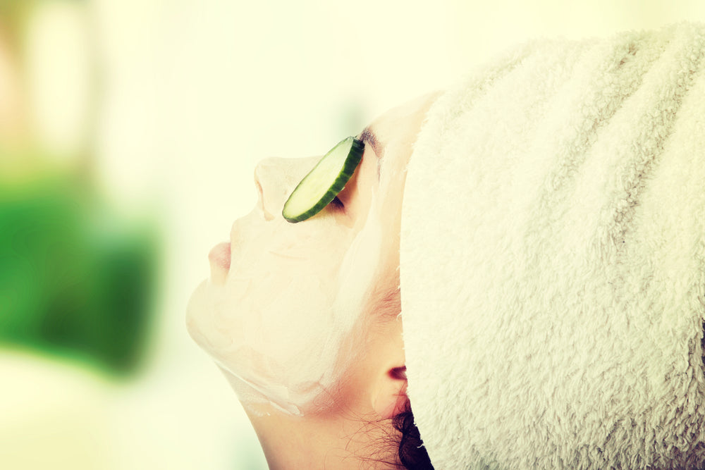 Woman with cucumber slices on eyes | Nourish Baby