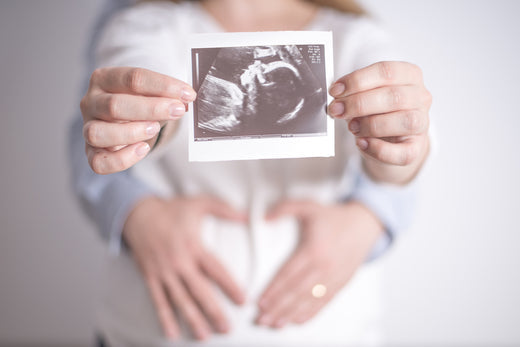 Woman with ultrasound photo | Nourish Baby