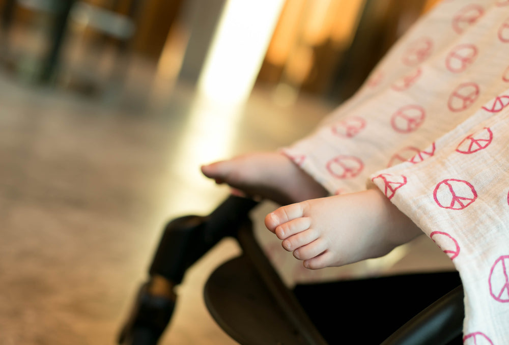 Baby's feet under blanket | Nourish Baby