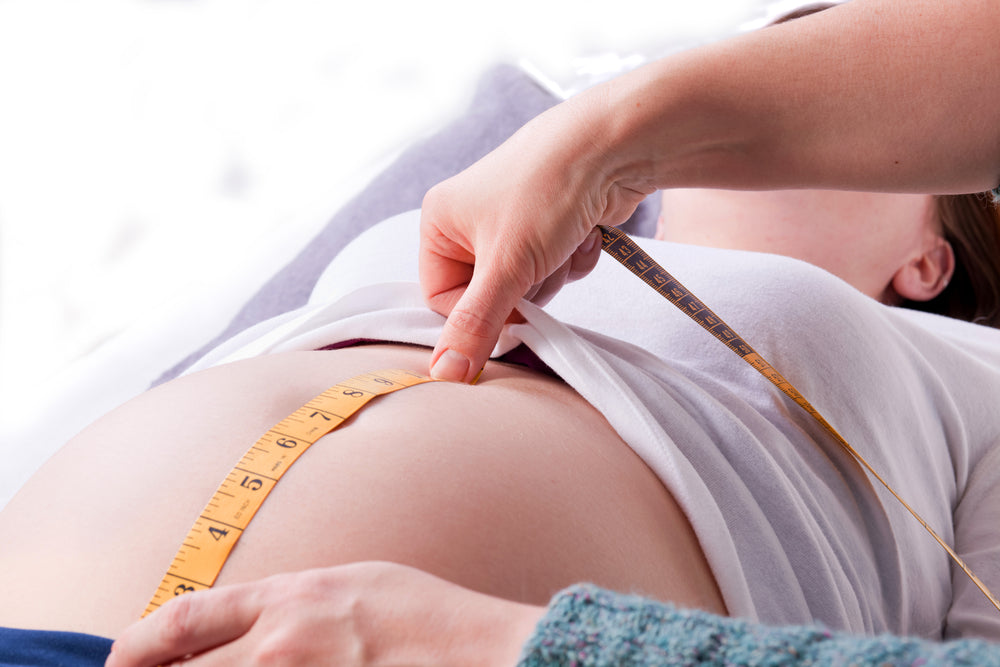 Pregnant woman having her belly measured | Nourish Baby