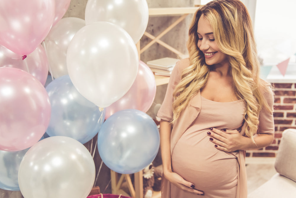 Pregnant woman with balloons  | Nourish Baby