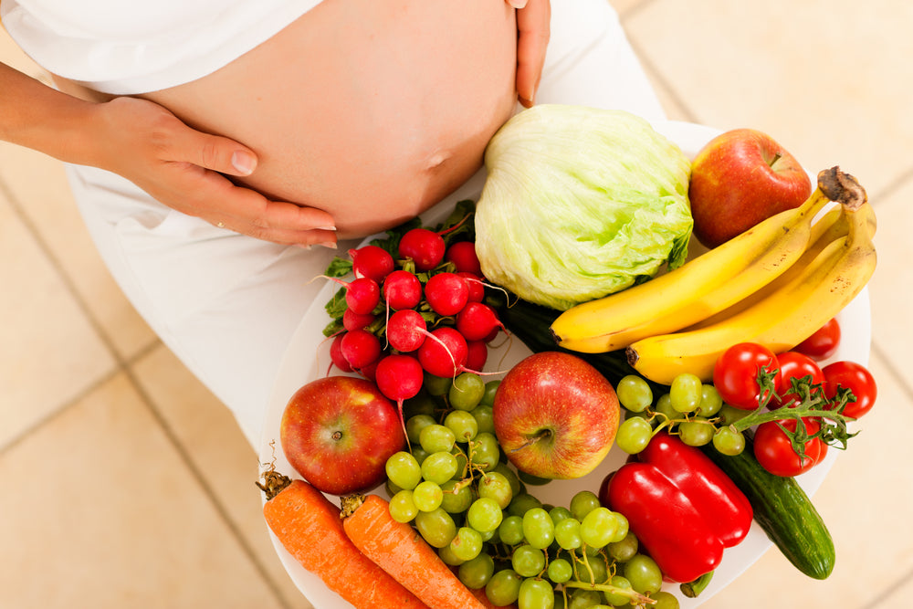 Pregnant woman with fruit & vegetables | Nourish Baby