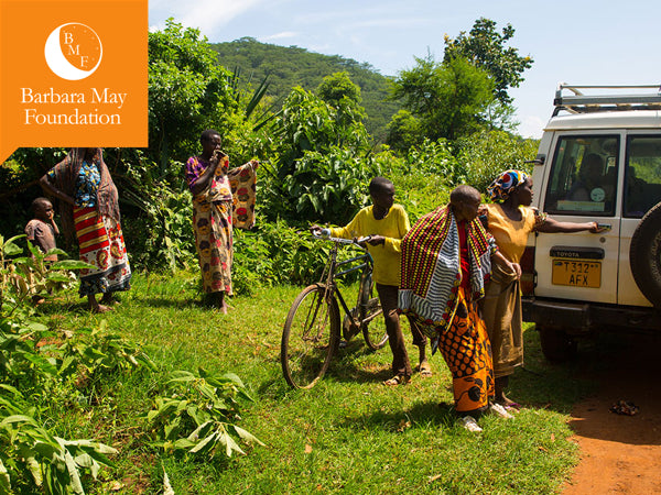 Barbara may foundation logo available on webpage. In image 5 people standing beside of car.